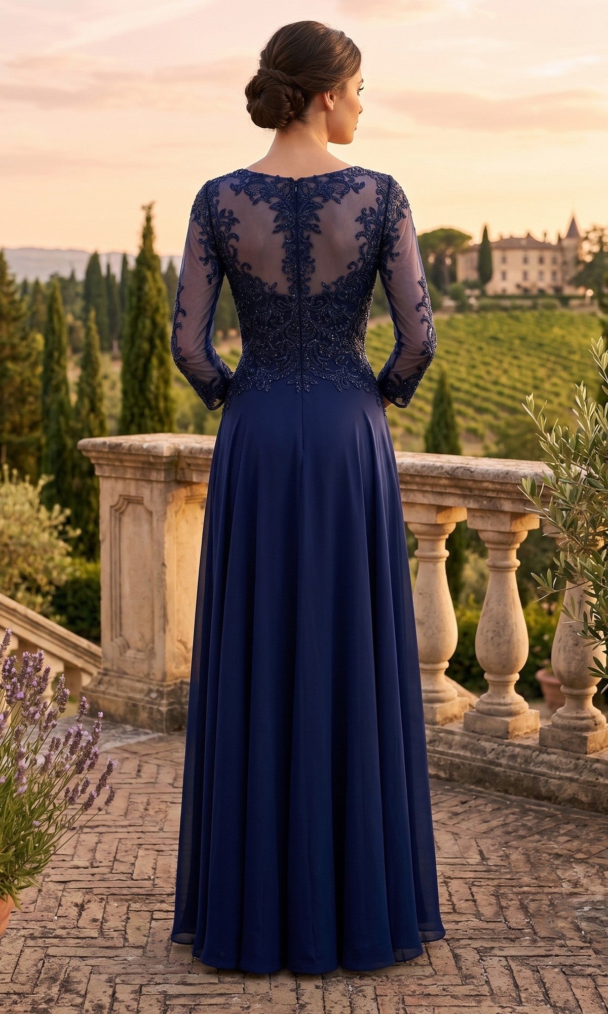 A woman in the Long Prom Dress: Chicas XR6014, a navy blue, floor-length gown featuring an embellished bodice and delicate lace detailing, stands on a terrace overlooking a scenic landscape at sunset.